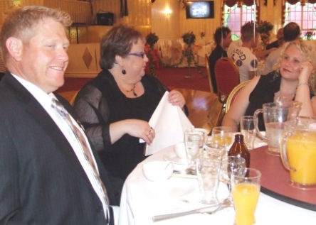 300-gamer and Life Member Darren Nagle takes a well-earned break from his compering duty - at the table with Robyn Storey and his partner Kim Simmons.